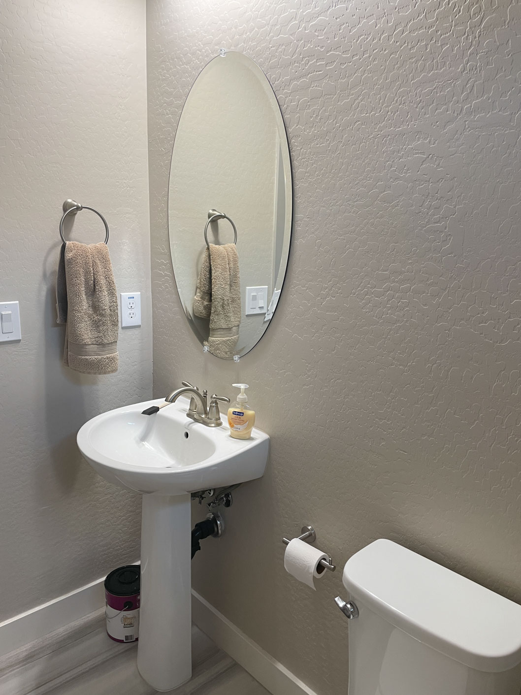 A bathroom with a mirror and sink.