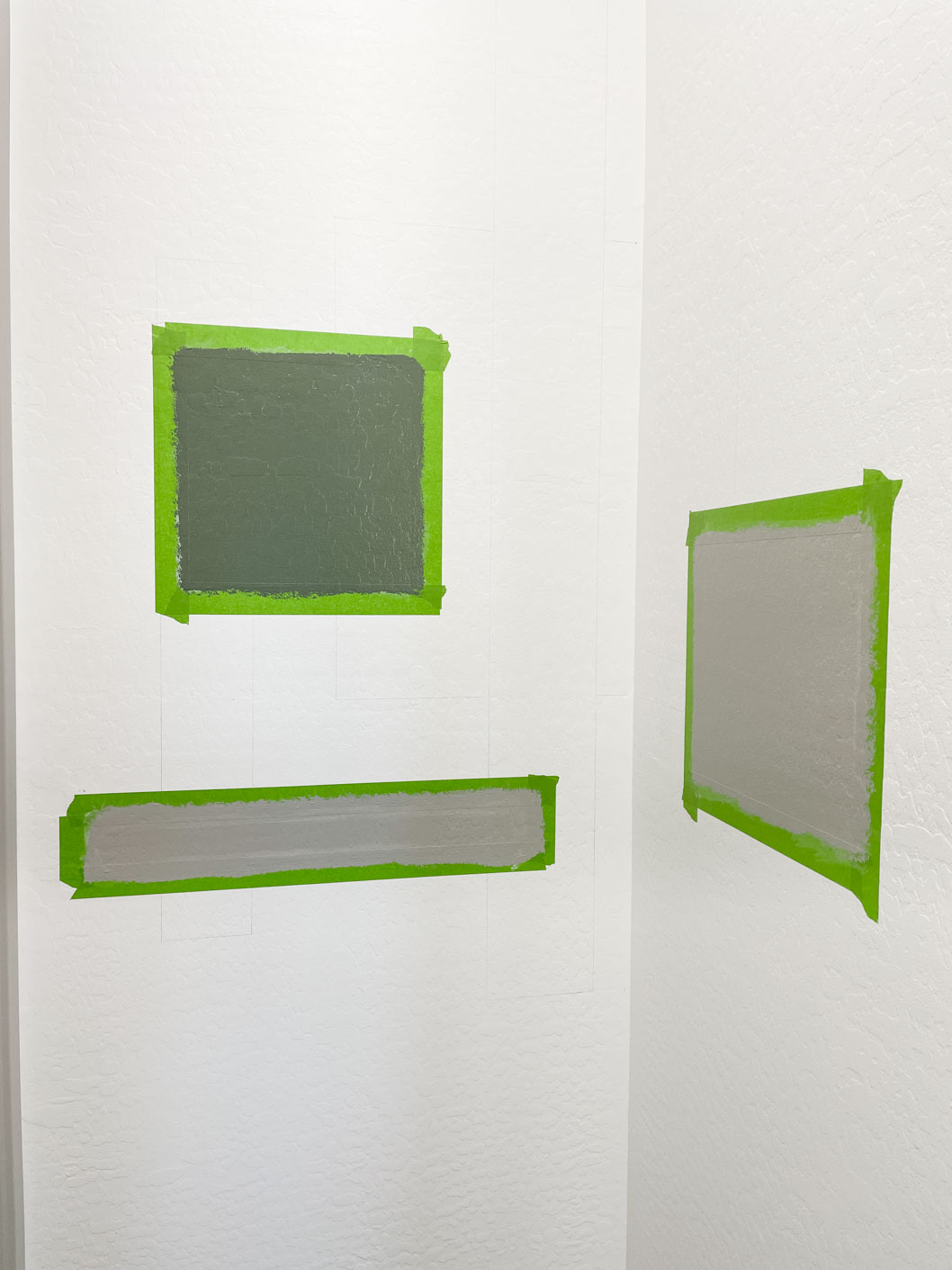 Using paint to create magic on a white wall with with green and gray paint.